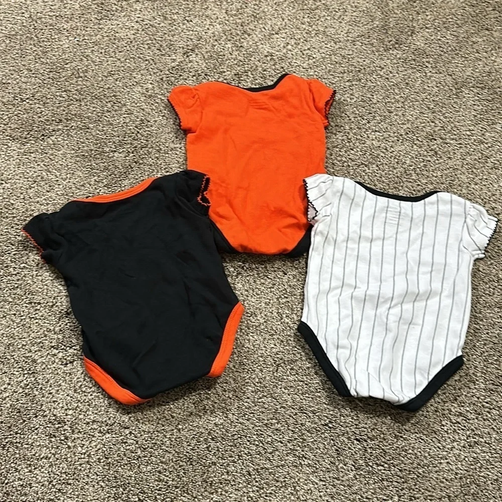 Toddler girls San Francisco Giants short sleeve onesies.